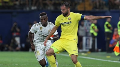Villareal's Mario Gaspar vies for the ball with Real Madrid's Vinicius Junior during the Spanish La Liga soccer match between Villarreal and Real Madrid in the Ceramica stadium in Villarreal, Spain. ap