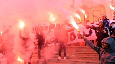 Tunisian protesters carry flares in central Tunis on January 14, 2018, marking the seventh anniversary since the uprising that ousted ex-president Zine El Abidine Ben Ali and launched the Arab Spring. Anis Mili / AFP