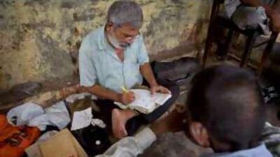 J C Sharma, centre, is one of the hundreds of professional letter writers who were asked to vacate their spots.