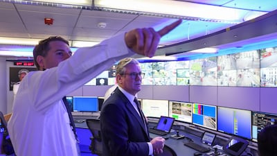 Mr Starmer views CCTV screens with Commander Ben Russell at the Metropolitan Police Command and Control Special Operations Room in Lambeth, in August