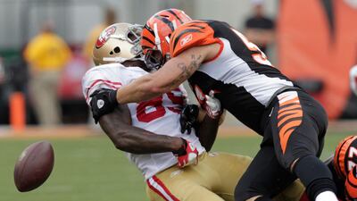 San Francisco 49ers tight end Vernon Davis (85) fumbles the football after being hit by Cincinnati Bengals' Dan Skuta (51) during the second half of play in their NFL football game Paul Brown Stadium in Cincinnati, Ohio, September 25, 2011. John Sommers /???