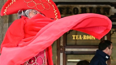 A man wears an Olympic Games-themed costume in St Mark's Square during the Venice Carnival. Italy is hosting the Milan-Cortina Winter Olympics. AFP
