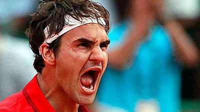 Roger Federer reacts after defeating Novak Djokovic at the Roland Garros stadium in Paris.