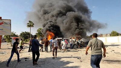 Men attempt to move vehicles to prevent them from catching fire after a car bomb explosion near a school in Benghazi, Libya. Esam Omran Al-Fetori / Reuters