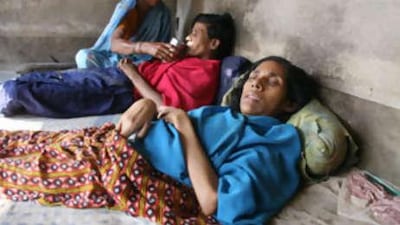 Ansara Bibi takes care of her two daughters, Rezina, foreground, and Fatema, who have both been bedridden since birth.