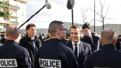 French President Emmanuel Macron meets police officers during a visit to the police station in the district of Bourtzwiller, in Mulhouse. Reuters