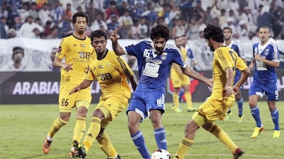 Hassan Mohamed, centre, was one of five Al Nasr players to find the net on Wednesday night as the hosts cruised past Al Wasl. Jeffrey E Biteng / The National