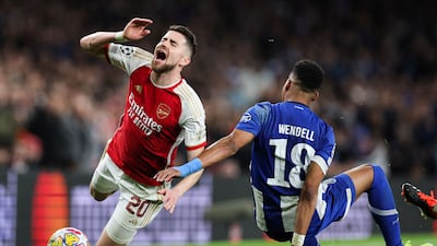 Arsenal midfielder Jorginho takes a tumble after being challenged by Porto defender Wendell. AFP