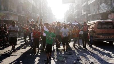 Syrians celebrate in the northern city of Aleppo on August 6, 2016, after rebels broke a three-week government siege on the city's opposition-held areas. Thaer Mohammed/AFP