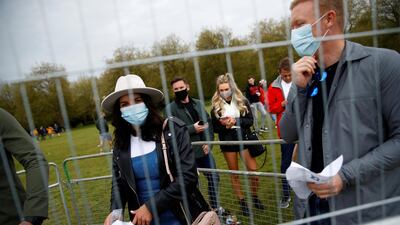 People queue to enter a test music festival as part of a national research programme. Reuters