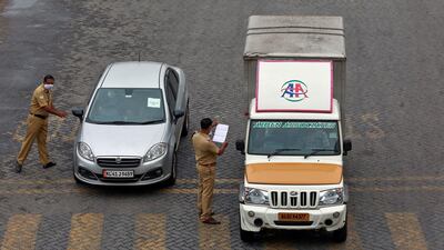 Police officers stop vehicles and check their papers on a highway during 21-day nationwide lockdown in Kochi, India. Reuters