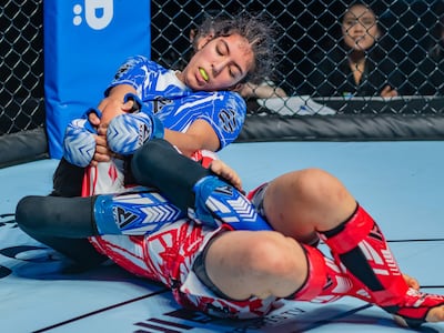 The UAE's Zamzam Al Hammadi, in blue, on her way to victory against Xerena Sikes. Image: UAEMMAF