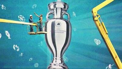 A TV screen in Kiev displaying the Uefa Euro 2012 trophy. The Union of European Football Associations is promoting the matches as meeting places for the business world. Sergei Supinsky / AFP