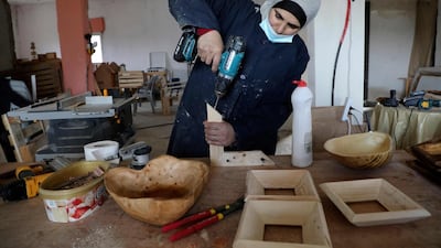 A Palestinian woman works at a carpenter workshop, established and run by a group of women, in the village of al-Walajeh near the West bank town of Bethlehem. AFP