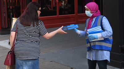A worker offers free Rapid Antigen tests to members of the public in Carnaby Street in London.
