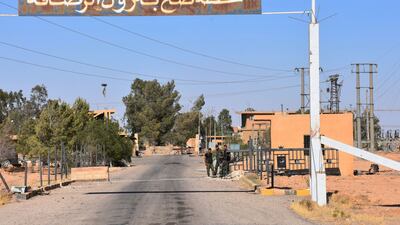 A picture taken on July 9, 2017 shows Syrian regime forces standing at the entrance of the Rasafa oil pumping station, situated southwest of the city of Raqqa. AFP / George Ourfalian