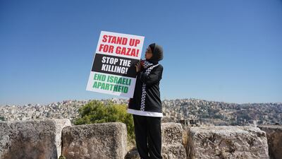 Team captain of Let Gaza Live football team, Marwa Salem, holds up protest signs in solidarity with Palestine. Amy McConaghy / The National