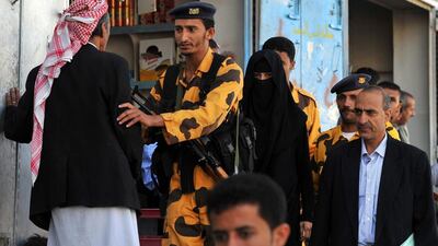 Yemeni soldiers escort Huda Abdullah Ali, 22, and her lawyer Abdulraqeeb Al Qadi (right) from a courtroom. Ms Ali is charged with illegally entering Yemen while her boyfriend Arafat Mohammed Taher Al Qadi, 25, is accused of helping her. Yahya Arhab / EPA
