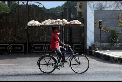 A bakery worker delivers bread in Cairo, Egypt's capital. EPA