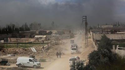 Vehicles carrying Syrians from Eastern Ghouta pass through a regime-controlled corridor in Hamouria on March 16, 2018, a day after the town was recaptured by government forces. AFP