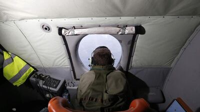 A crewman aboard a Royal New Zealand Air Force P-3K2 Orion aircraft searches for missing Malaysian Airlines flight MH370 over the southern Indian Ocean. Jason Reed / Reuters
