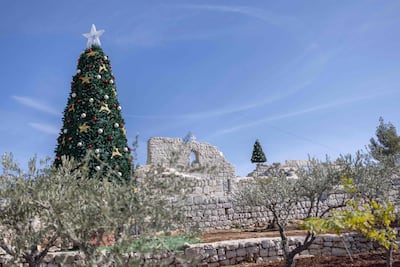 Christmas trees in the gardens of Saint George Greek Melkite Catholic Church in Taybeh. AFP
