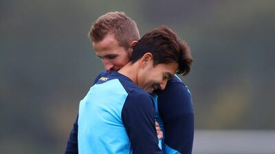 Harry Kane hugs Spurs teammate Son Heung-min during training. Clive Rose / Getty Images
