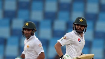 Pakistani batsmen Azhar Ali, right, and Sami Aslam run between the wickets. Aamir Qureshi / AFP