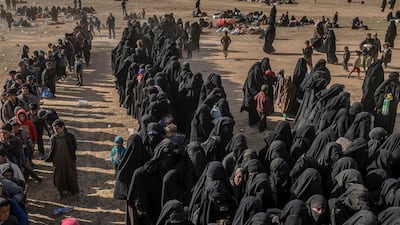 Civilians evacuated from ISIS's embattled holdout of Baghouz wait at a screening area held by the US-backed Kurdish-led Syrian Democratic Forces (SDF), in the eastern Syrian province of Deir Ezzor. AFP