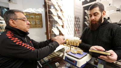A customer looks at gold bracelets inside a jewellery shop in Beirut, Lebanon. REUTERS