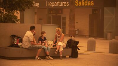 Passengers wait outside Tenerife South–Reina Sofia Airport after flights were cancelled due to a sandstorm on February 23, 2020 on the Canary Island of Tenerife. AFP