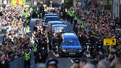 Members of the public gather to watch the procession, from the Palace of Holyroodhouse to St Giles Cathedral, on the Royal Mile. AFP