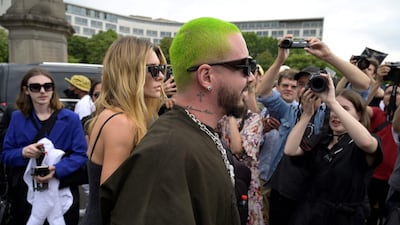 Colombian singer J Balvin, right, and Argentine model Valentina Ferrer arrive to attend the Givenchy show. AFP