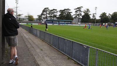 A fan watches the FA Cup preliminary round match between Stansted and Tilbury on Sunday in Bishop's Stortford, England. Harry Hubbard / Getty Images