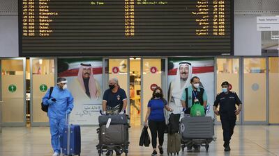 Travellers arrive at Kuwait International Airport on Saturday, August 1, 2020. Commercial flights there have resumed after five months of restrictions. AFP