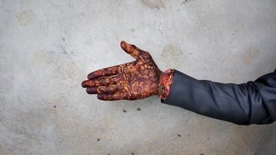 A groom shows his hand decorated with Hena as he takes part a mass marriage celebration near Bhopal. Harish Tyagi / EPA
