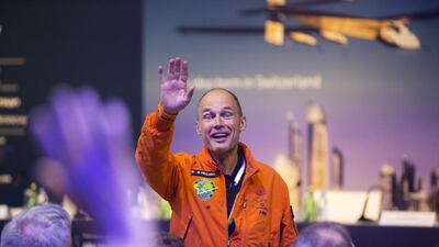 Pilot Bertrand Piccard waves to a supporter before the press conference in Abu Dhabi. Christopher Pike / The National