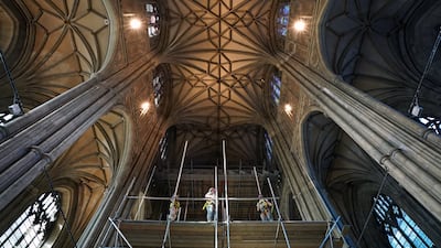 Scaffolders remove the platform used during the five-year restoration of the nave ceiling vaulting in Canterbury Cathedral, on Tuesday, revealing the renovation work. PA