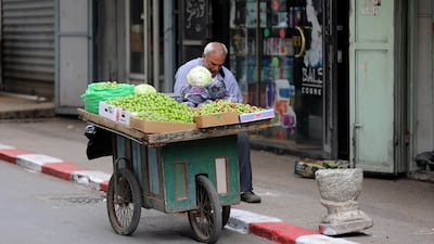 Palestinian vendor waits for customers during the Islamic holy month of Ramadan, in the West Bank city of Nablus. EPA