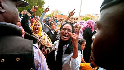 Demonstrators chant slogans as they protest outside the courthouse where the trial is held for Sudan's ousted president Omar Al Bashir along with 27 co-accused over the 1989 military coup that brought him to power. AFP
