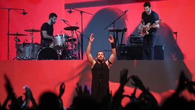 Hamed Sinno, the lead singer of Lebanese band Mashrou Leila, performs on stage at the Dubai International Marine Club. Courtesy AFP / KARIM SAHIB