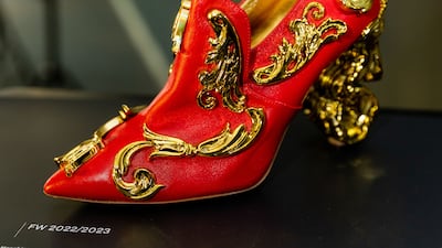 A red and golden shoe by Moschino