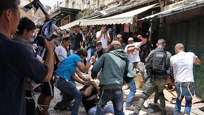 Israelis beat a Palestinian man in the Old City of Jerusalem. AFP