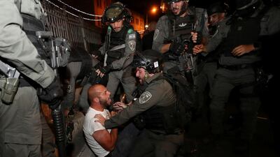 A Palestinian protester is detained during clashes with Israeli police, as the Muslim holy fasting month of Ramadan continues, in Jerusalem. Reuters