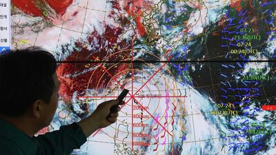A weather forecaster points out the current position of Typhoon Gaemi moving northward towards the Korean Peninsula on a display at a local meteorological agency in Suwon, 30 kilometres south of Seoul, South Korea. EPA