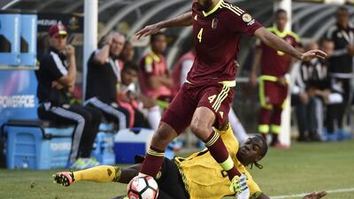 Jamaica’s Clayton Donaldson and Venezuela’s Oswaldo Vizcarrondo vie for the ball. Omar Torres / AP Photo