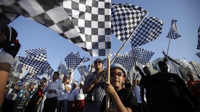 Bushkar Nadella, 6, joins hundreds of people in Abu Dhabi attempt to break the Guinness World Record for The Most People Waving Checkered Flags as part of the Yasalam festival in Abu Dhabi October 24, 2013. Sammy Dallal / The National