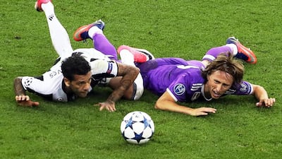 Real Madrid’s Luka Modric, right, in action against Juventus’ Dani Alves. Geoff Caddick / EPA