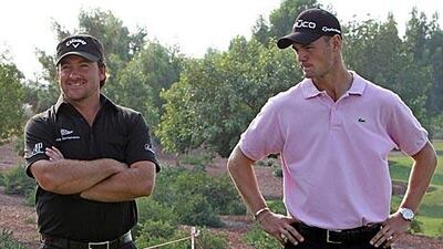 Martin Kaymer, right, sizes up his Race to Dubai rival Graeme McDowell yesterday at the Earth Course.