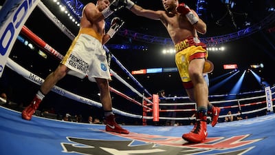 Alberto Guevara (white trunks) and Isaac Lowe (red/yellow trunks) box during their featherweight bout at MGM Grand Garden Arena, Las Vegas. Reuters